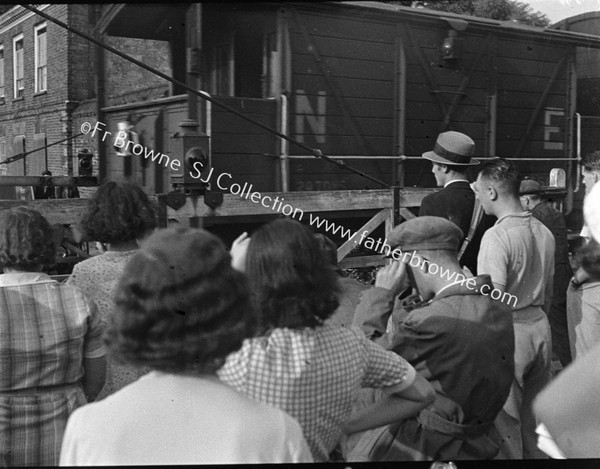 PEOPLE AT LEVEL CROSSING GATE  NE TRAIN